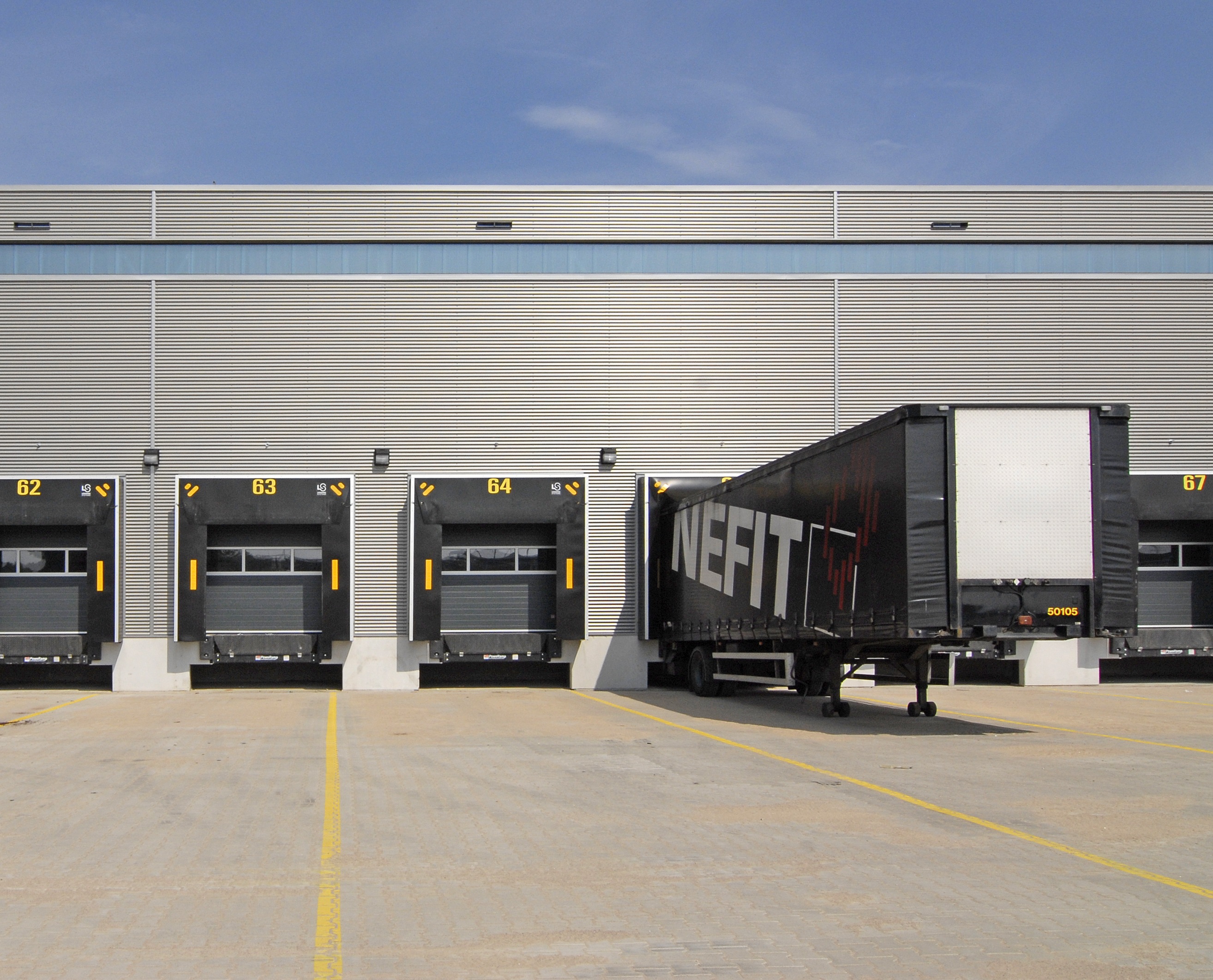 Trailer positioned at a modern warehouse loading dock